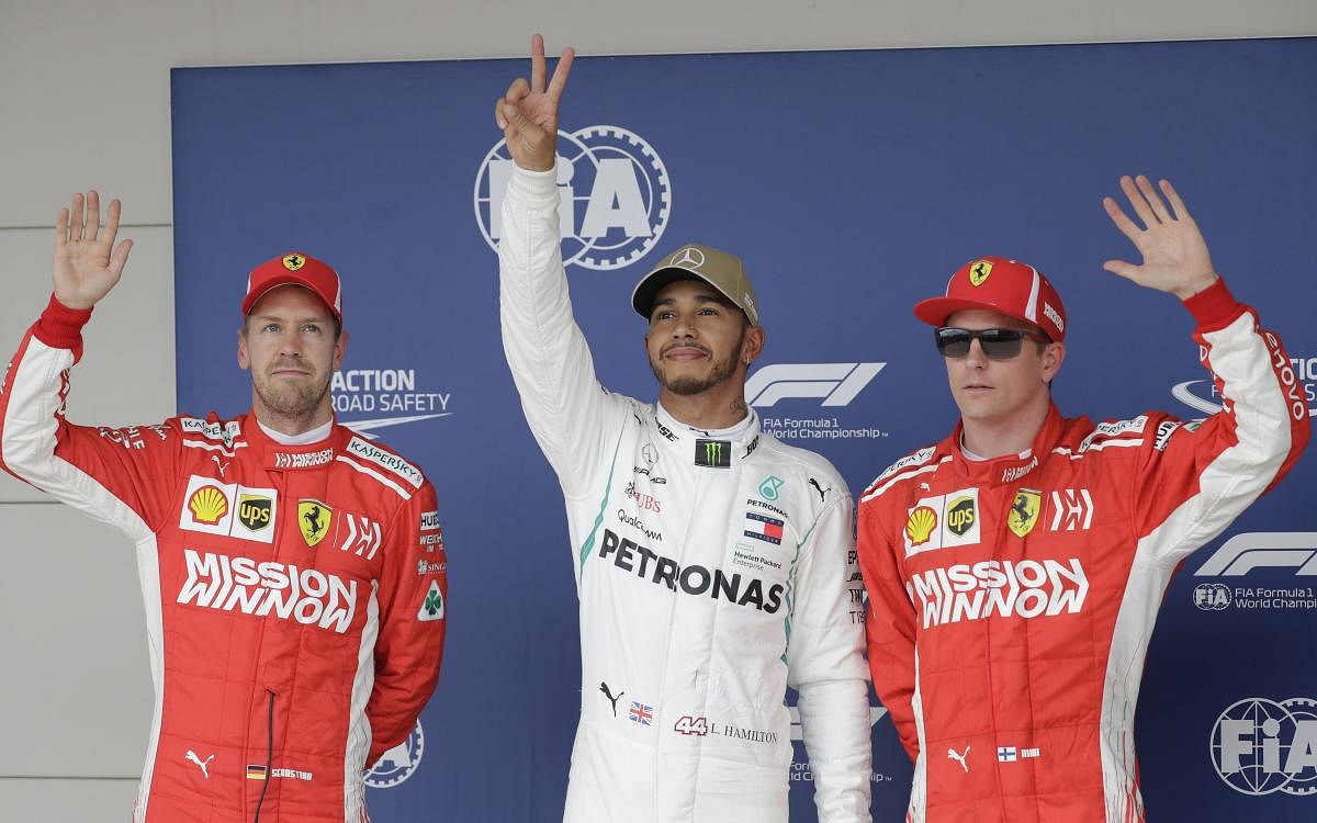 DELIGHTED Mercedes' Lewis Hamilton (centre) waves to the crowd after taking pole position for the United States GP on Saturday.
