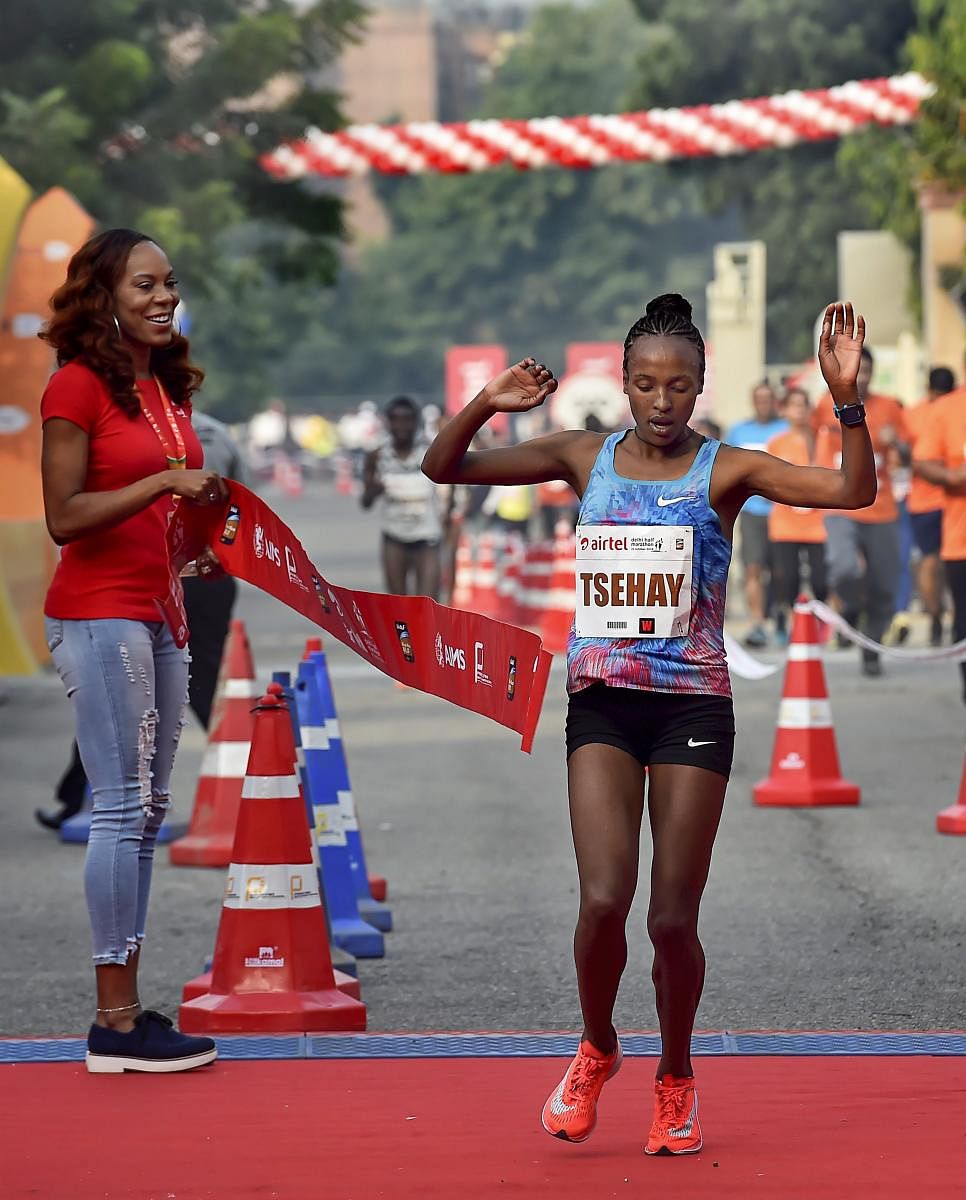 TRIUMPHANT: Ethiopia's Tsehay Gemechu crosses the finish line to win the Delhi Half Marathon title. PTI