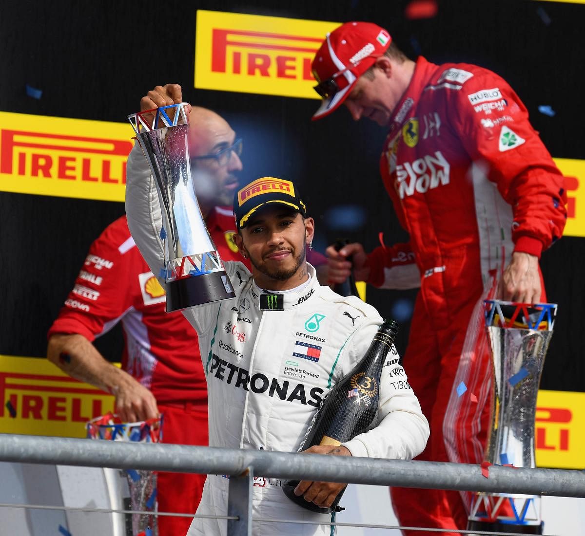 Third placed Lewis Hamilton of Mercedes celebrates on the podium after the United States Grand Prix. AFP