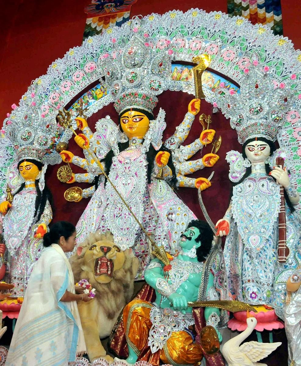 West Bengal Chief Minister Mamata Banerjee offering prayer during the inauguration of Goddess Durga Puja ahead of Durga Puja festival, in Kolkata. PTI file Photo
