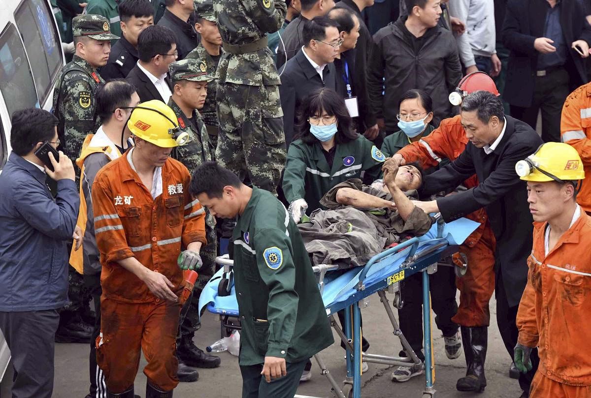 In this photo released by China's Xinhua News Agency, a worker is carried on a stretcher out of the Longyun coal mine in Yuncheng County, east China's Shandong Province on Sunday. AP/PTI