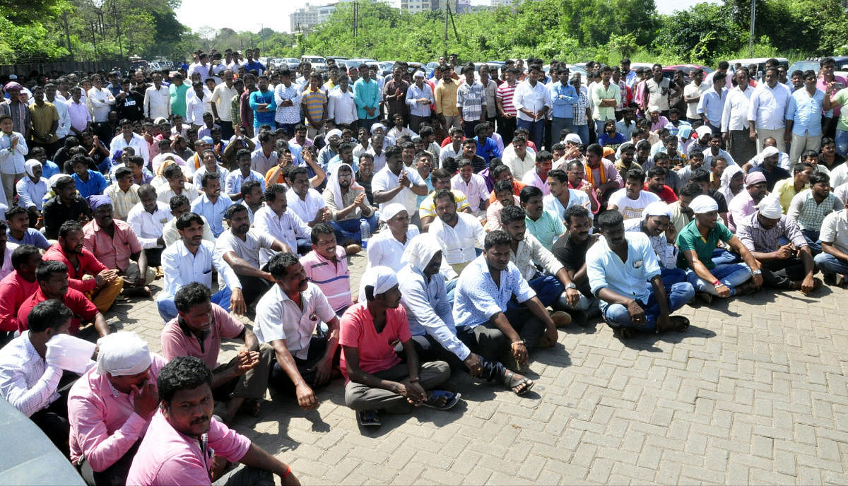 Udupi district Construction Materials Transport Vehicles Owners and Drivers Association members stage a protest in front of DC office in Manipal on Monday.