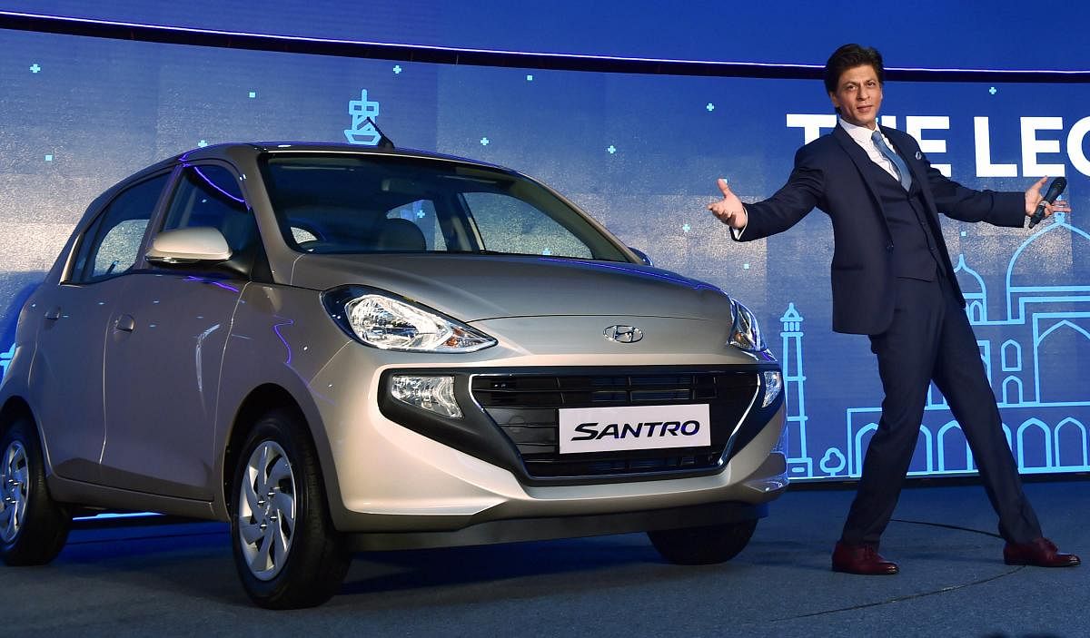 Bollywood actor &amp; Hyundai brand ambassador Shah Rukh Khan poses for photos at the launch of the new Santro in New Delhi. PTI file photo