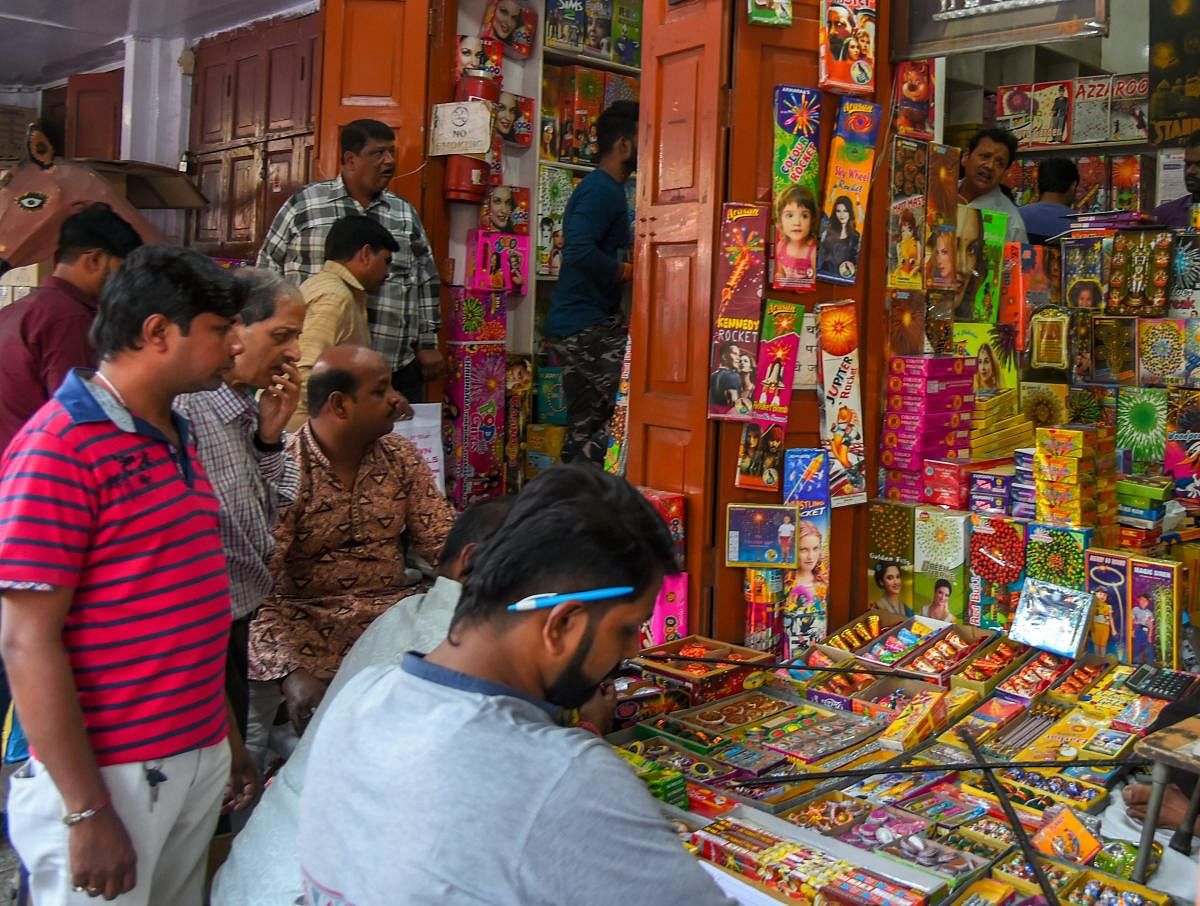 People purchase firecrackers in a market ahead of the festival of Diwali in New Delhi. PTI photo