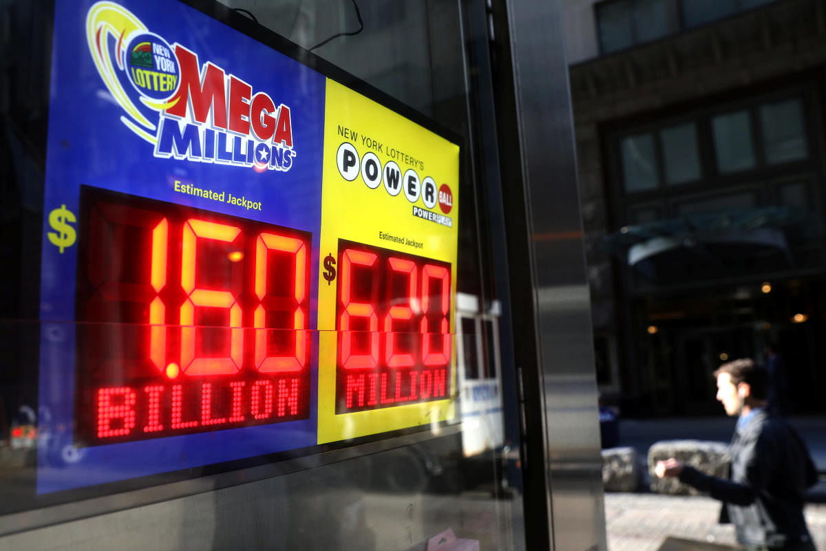 Signs display the jackpots for Tuesday's Mega Millions and Wednesday's Powerball lottery drawings in New York City. (Reuters photo)