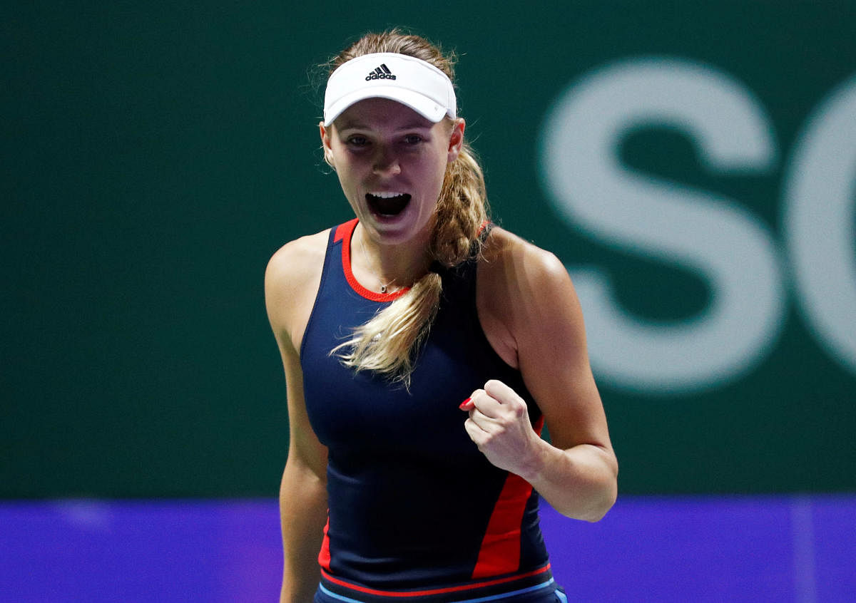 Denmark's Caroline Wozniacki celebrates after winning her group stage match against Czech Republic's Petra Kvitova. REUTERS