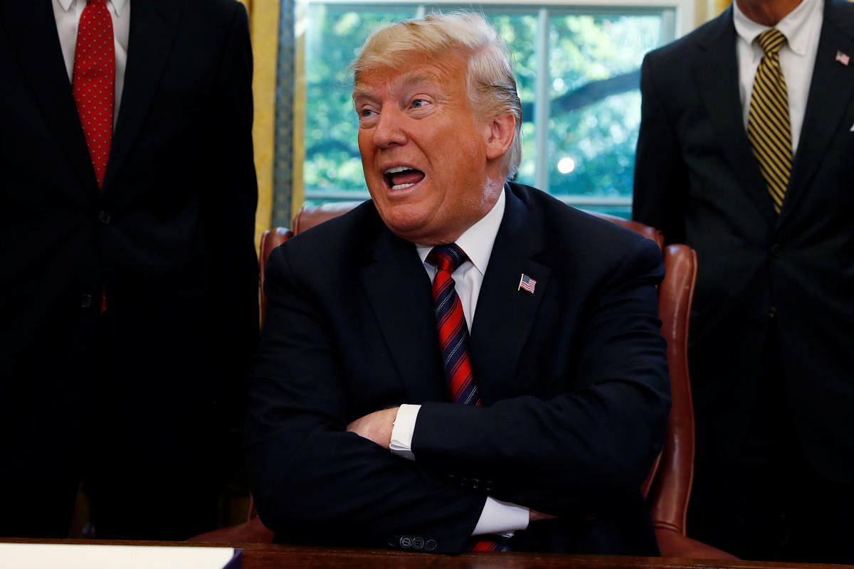 US President Donald Trump talks to reporters about the killing of journalist Jamal Khashoggi in Turkey during a bill signing ceremony at the White House in Washington, October 23, 2018. (REUTERS)