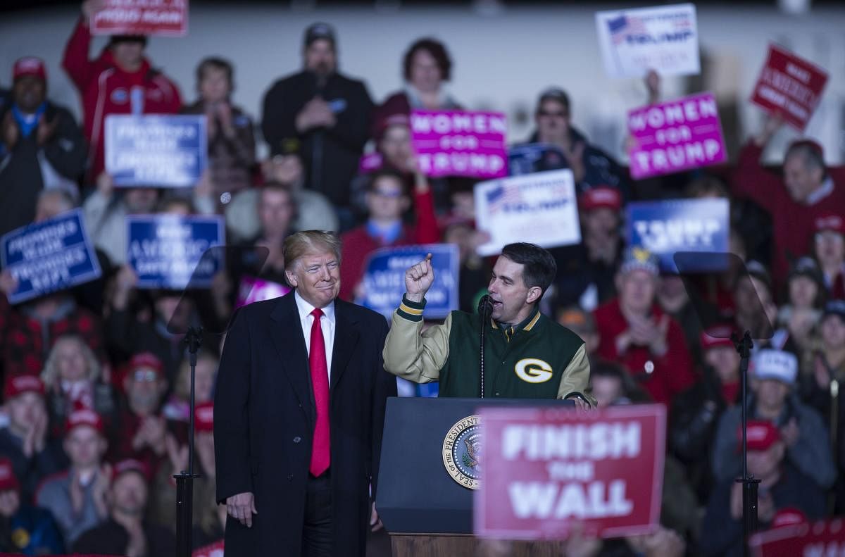 U.S. President Donald Trump appears with Wisconsin Gov. Scott Walker (R) at a political raly in Mosinee, Wisconsin. AFP