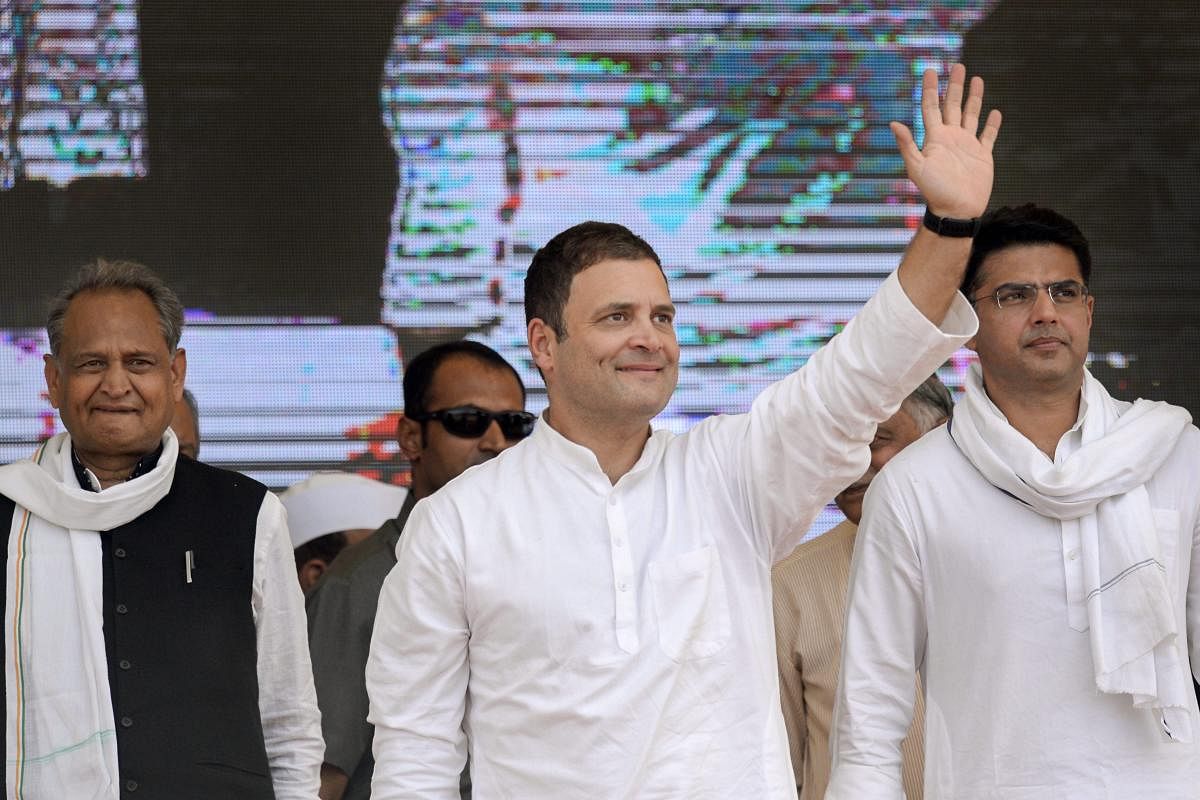 Congress President Rahul Gandhi waves at crowd during a public meeting in Jhalawar, Rajasthan, on Wednesday. RPCC President Sachin Pilot and former chief minister Ashok Gehlot are also seen. PTI