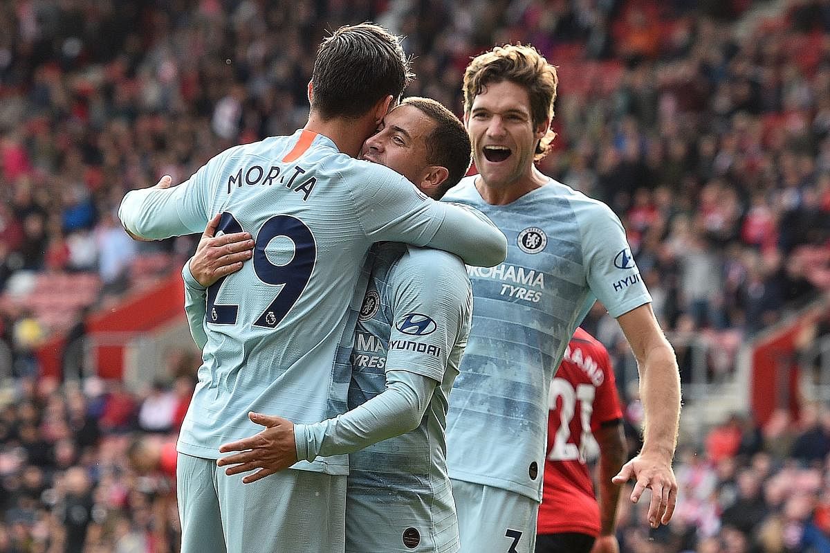 Chelsea's Alvaro Morata (left) celebrates with team-mates Eden Hazard (centre) and Marcos Alonso after scoring against Southampton. AFP 