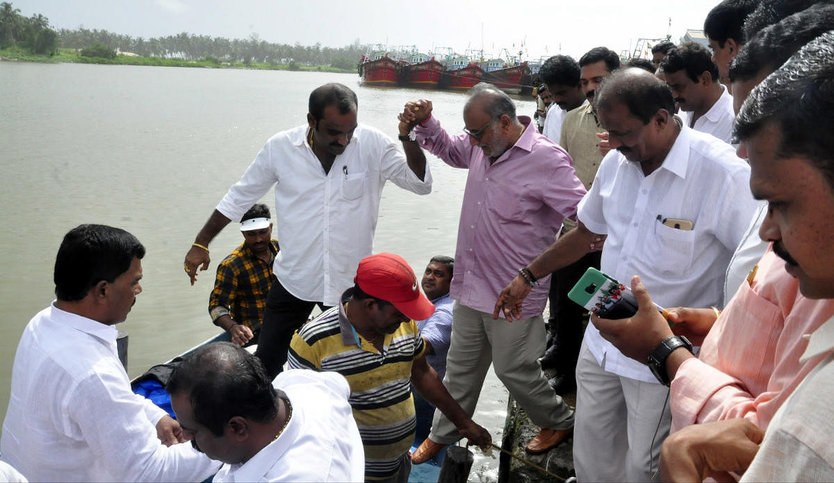 Minister for Animal Husbandry and Fisheries Venkata Rao Nadagouda inspects an electrically run fishing boat at Malpe harbour on Wednesday.
