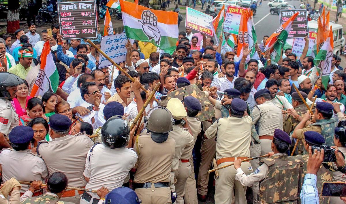 Police stop Madhya Pradesh Congress workers who were holding a demonstration at Raj Bhawan over hike in the prices of diesel, petrol and LPG cylinders, in Bhopal, Friday. PTI