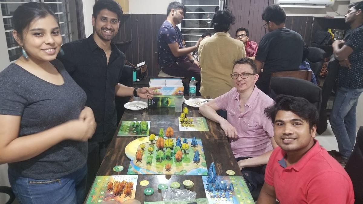 People play board games during a weekly meet-up.