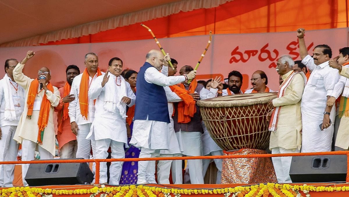 BJP president Amit Shah beats a drum as the party begins its campaign in the poll-bound state, in Hyderabad, on Saturday. PTI