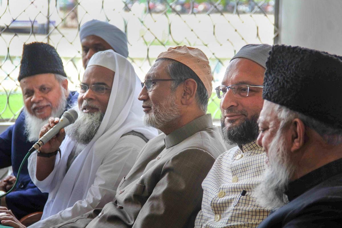 All India Muslim Personal Law Board General Secretary Maulana Khalid Saifullah Rahmani (holding mike), MP Asaduddin Owasis (2nd R) and others address the media on the issue of 'triple talaq' at Darussalam, Hyderabad, Thursday. PTI