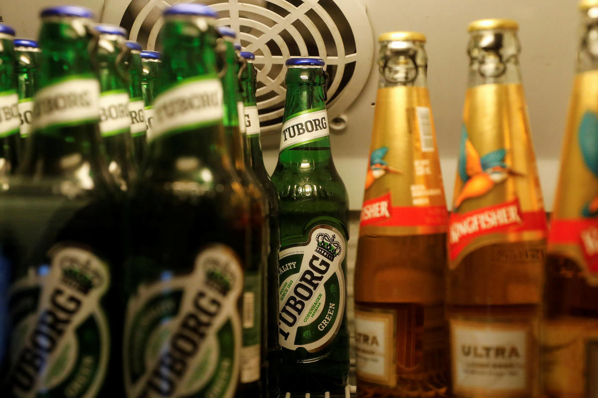 Bottles of Kingfisher and Tuborg beer are displayed in a fridge at a pub in Mumbai, India. Reuters
