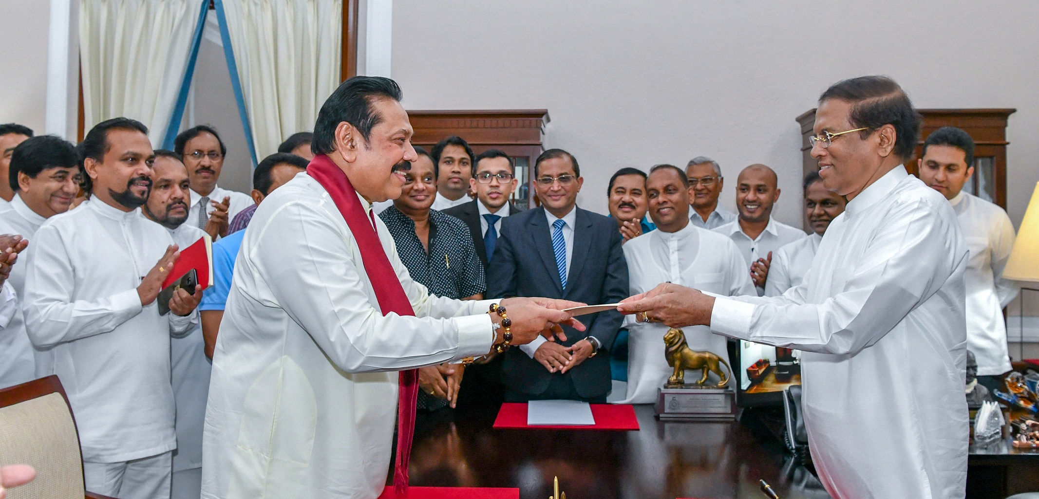 Sri Lanka's former President Mahinda Rajapaksa (Front-L) is sworn in as the new Prime Minister before President Maithripala Sirisena in Colombo on Friday. Reuters