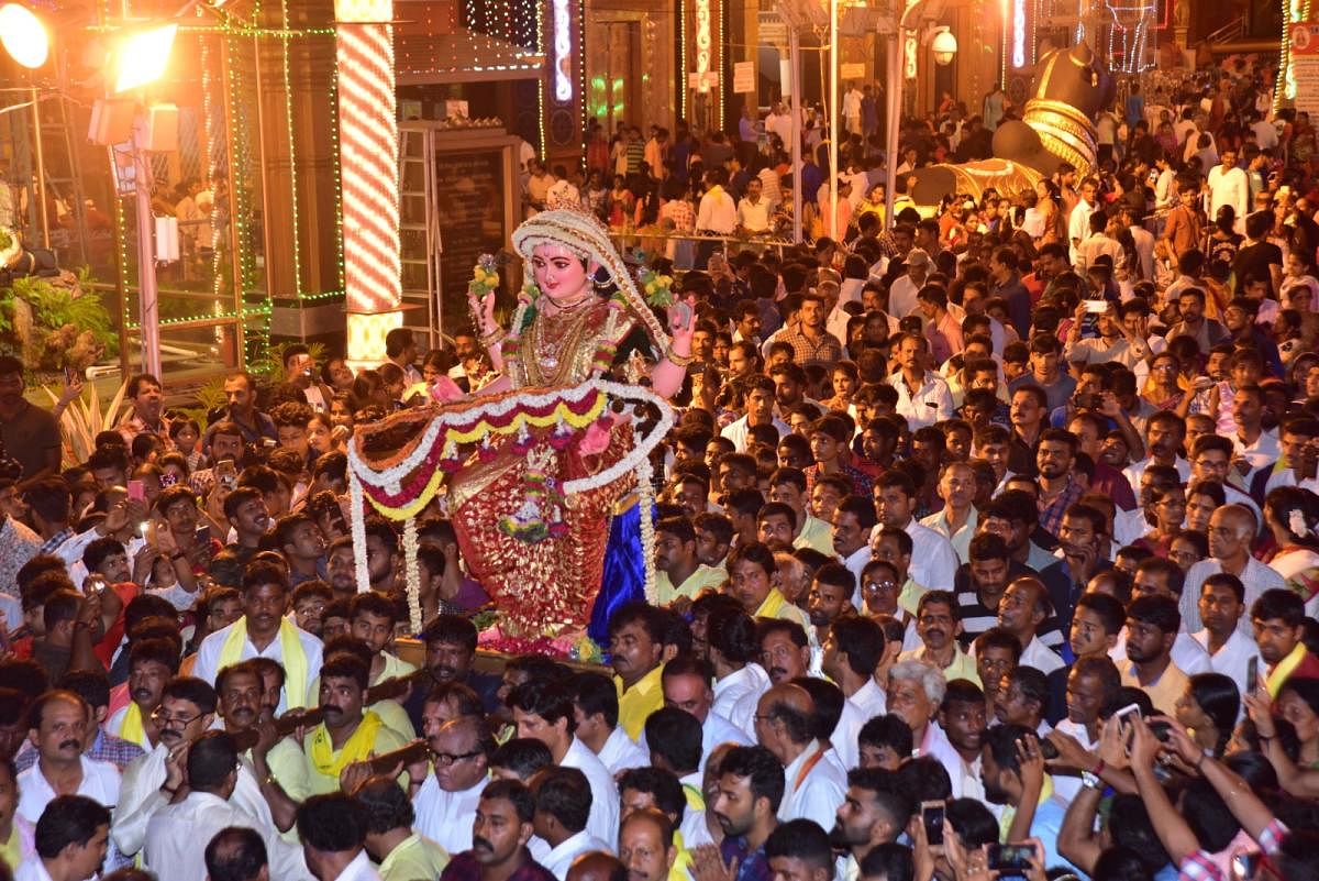 The idol of Goddess Sharada being carried by devotees to the tableau parked outside Kudroli Sri Gokarnanatha temple in Kudroli on Friday evening.