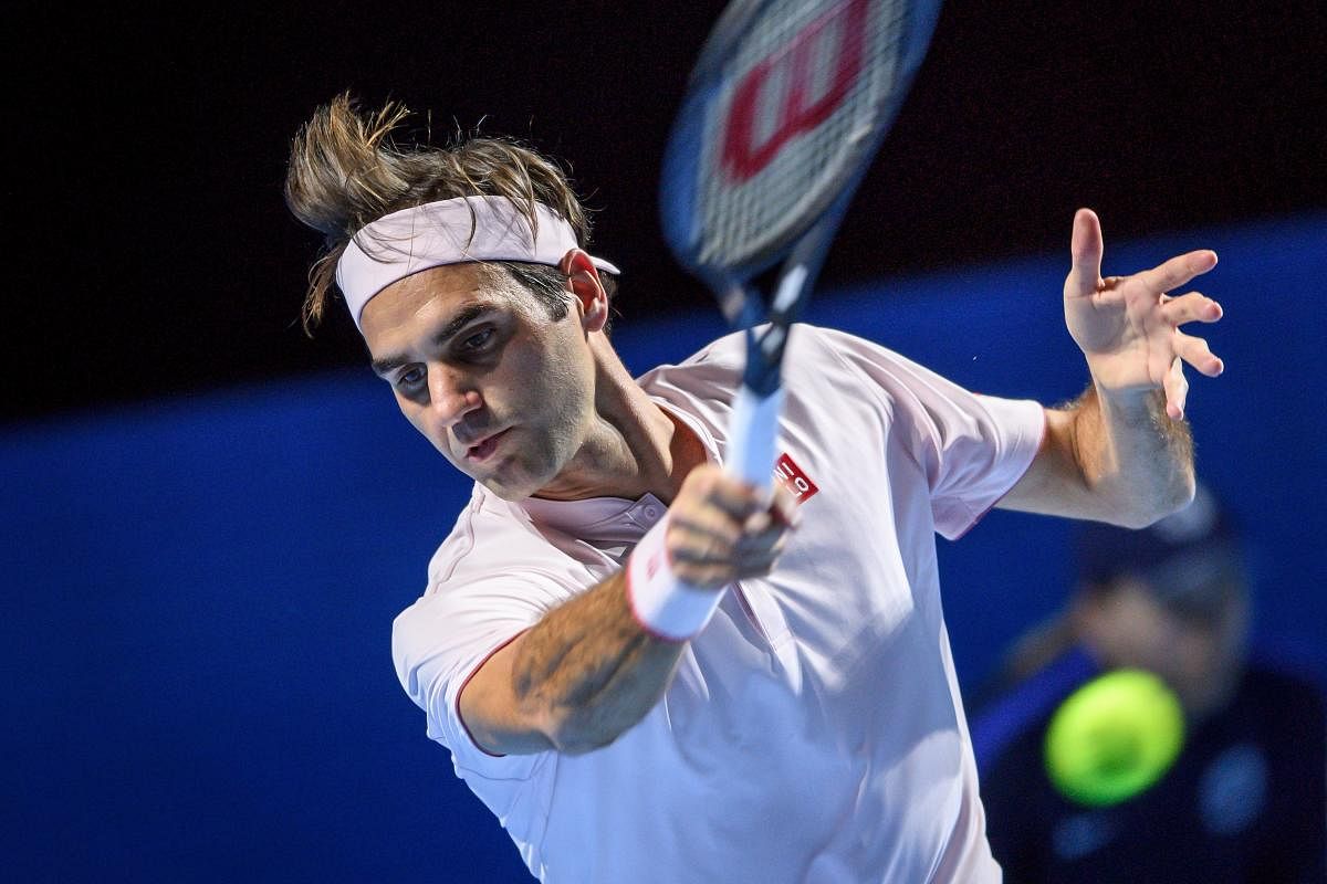 Switzerland's Roger Federer executes a forehand return to France's Gilles Simon during their quarterfinal match at the Swiss Indoors. AFP