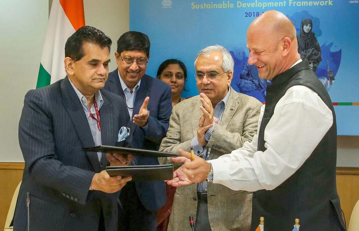 UN: NITI Aayog CEO Amitabh Kant (L) exchange documents with United Nations Resident Coordinator in India Yuri Afanasiev (R) after signing Sustainable Development Framework for 2018-2022, in UN, Friday, Sept 28, 2018. Also seen are as Joint Secretary Vikra