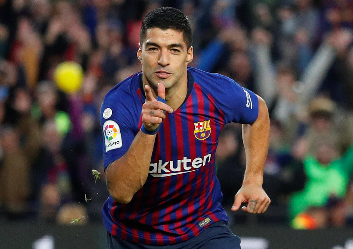 DAZZLING DISPLAY: Barcelona's Luis Suarez celebrates after scoring against Real Madrid during their La Liga clash on Sunday. REUTERS