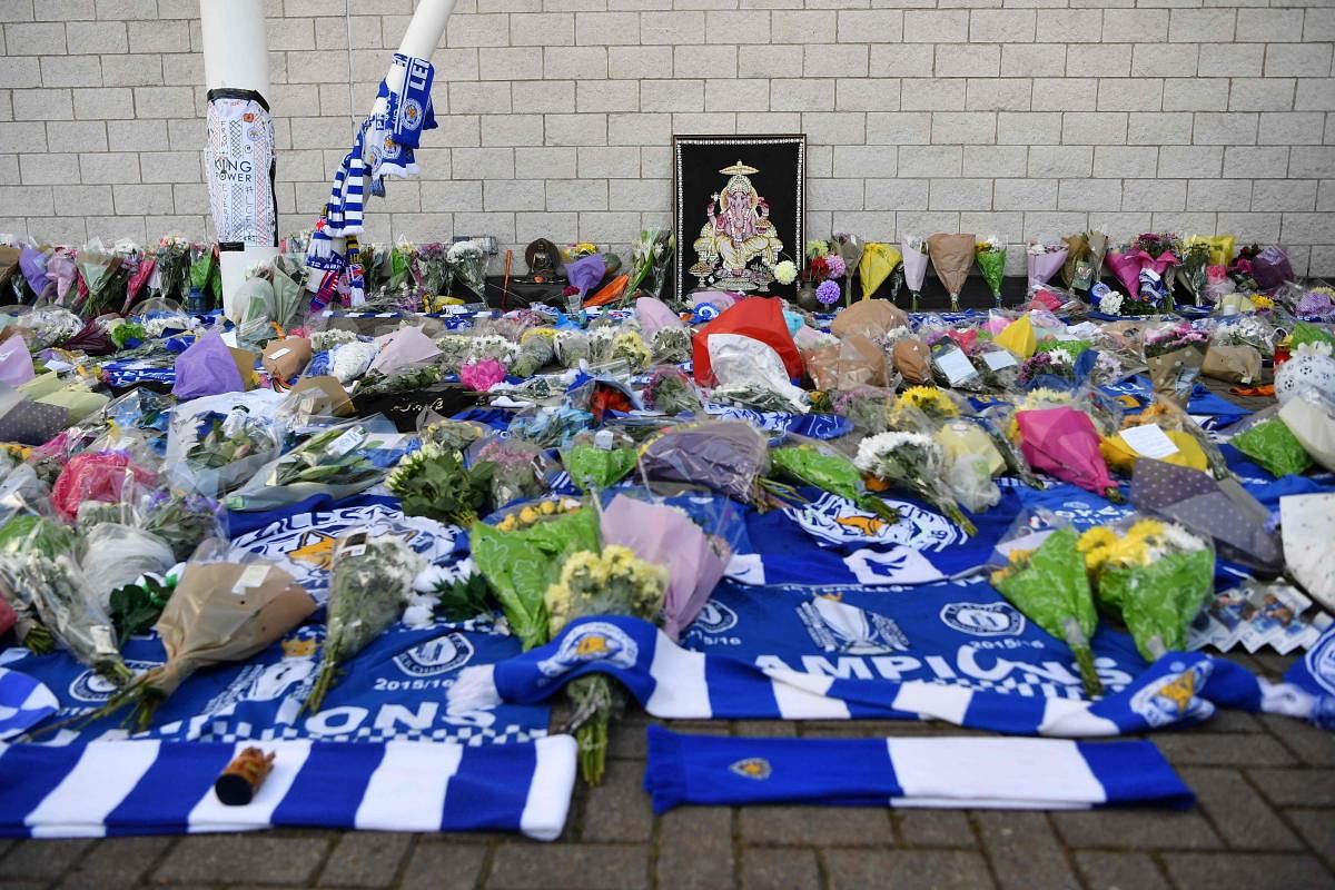 TRAGIC Fans pay tribute outside the King Power Stadium after Leicester City owner Vichai Srivaddhanaprabha was feared dead in a helicopter crash on Saturday. AFP