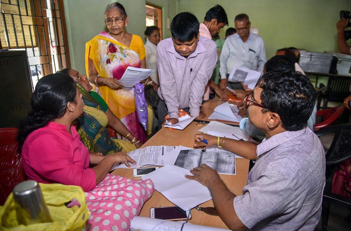 People verify the National Register of Citizens (NRC) forms to file claims and objections at an NRC centre, in Guwahati, on September 25, 2018. PTI file photo