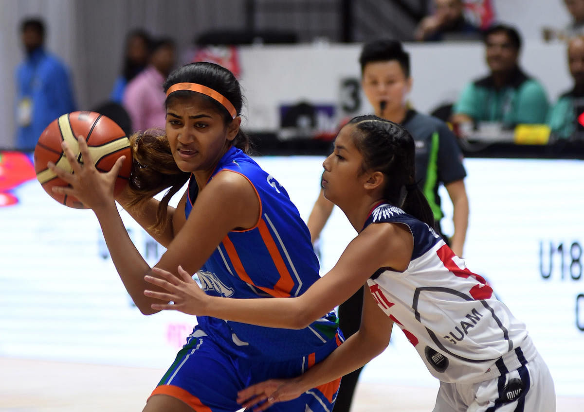 SURGING AHEAD India's Srishti Suren attempts to dribble past Alana Salas of Guam on Monday. DH Photo/ Srikanta Sharma R