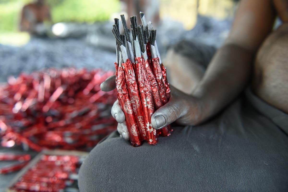 A worker prepares firecrackers at a workshop ahead of Diwali on the outskirts of Ahmedabad. AFP