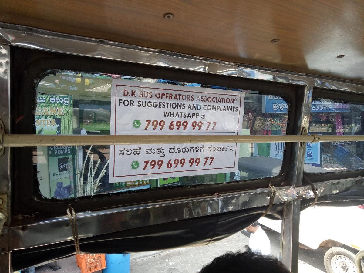 A sticker inside a private city bus in Mangaluru encouraging passengers to lodge complaints and pictures on the WhatsApp helpline.