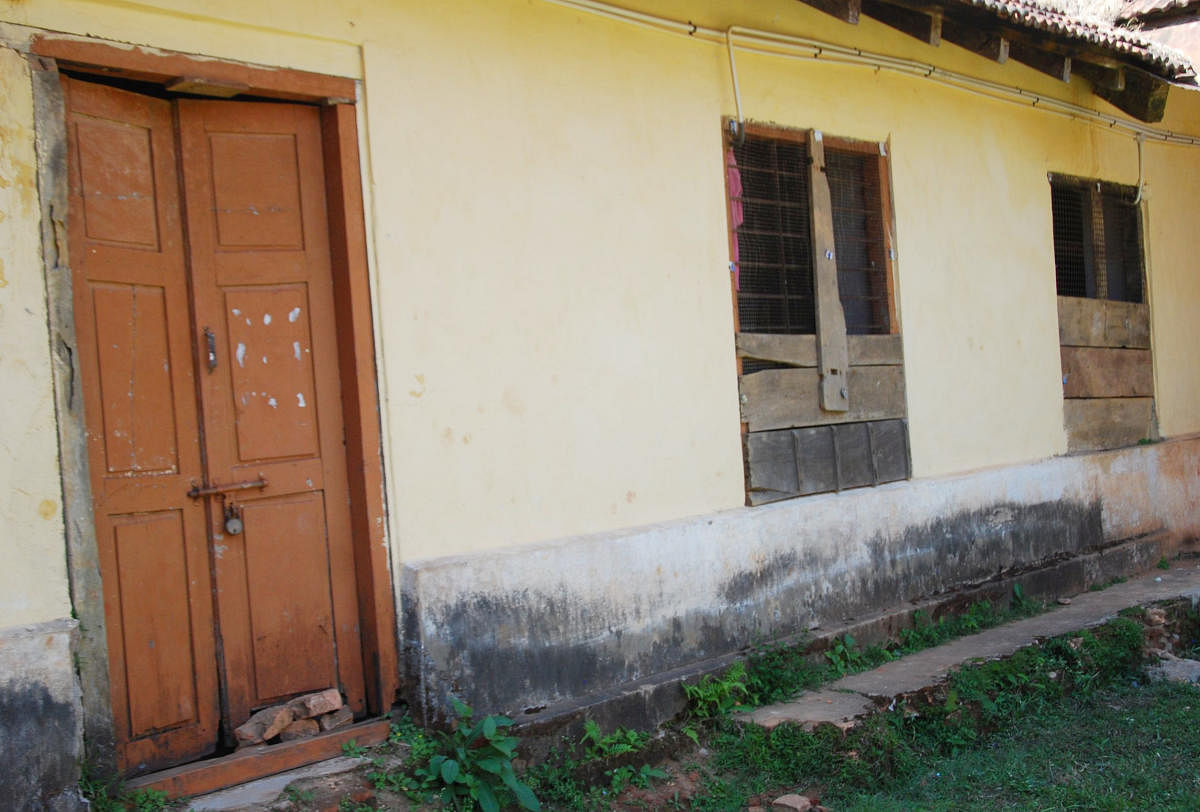 The broken door and windows of the Government First Grade College building in Madikeri.