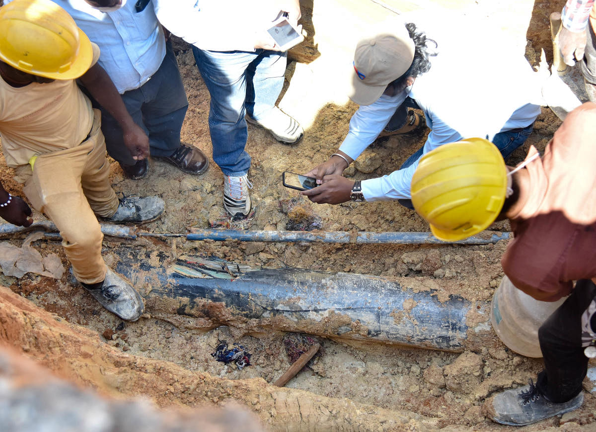 A team of GAIL officials inspects the damaged pipeline in Garudacharapalya on Whitefield Main Road on Monday.