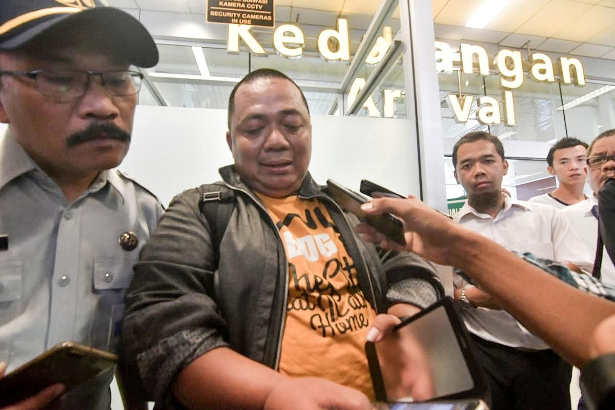 Sony Setiawan (C) speaks to journalists at Pangkal Pinang airport in Bangka Belitung province. AFP photo