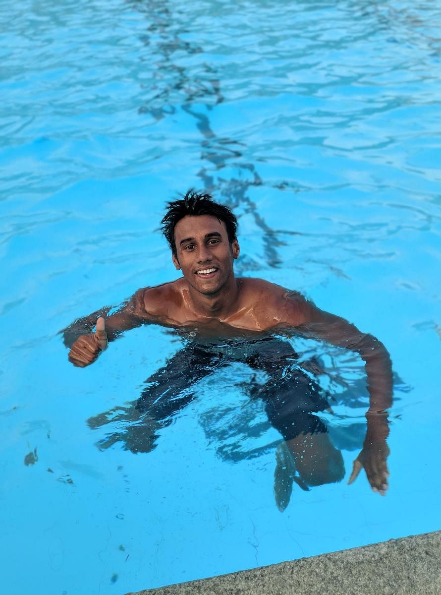 JUBILANT: Jain University's Likith SP celebrates after setting a new meet record in the 100M breaststroke event on Tuesday. 
