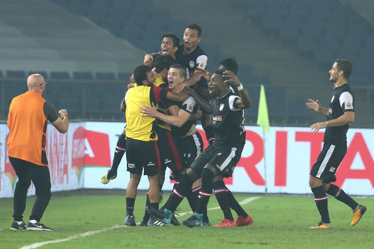 JUBILANT: NEUFC players celebrate after their win over hosts Delhi Dynamos on Tuesday. ISL  