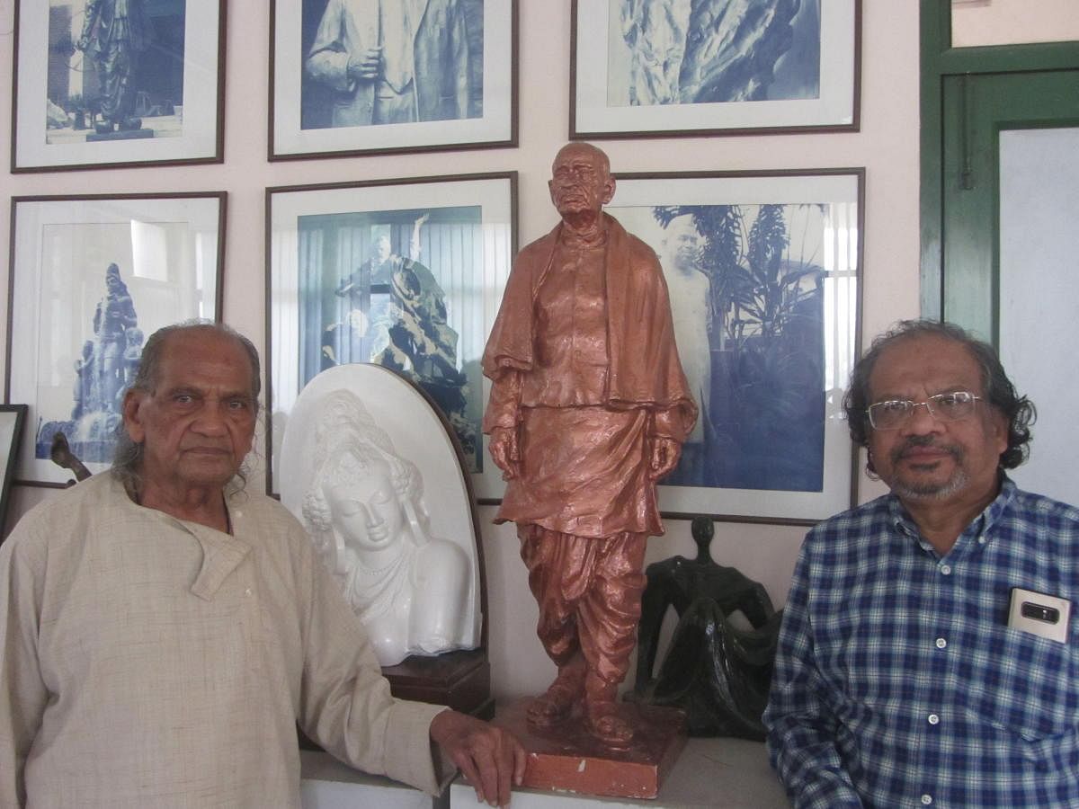 Ram Sutar and son Anil Sutar with a three-foot model of the Statue of Unity.