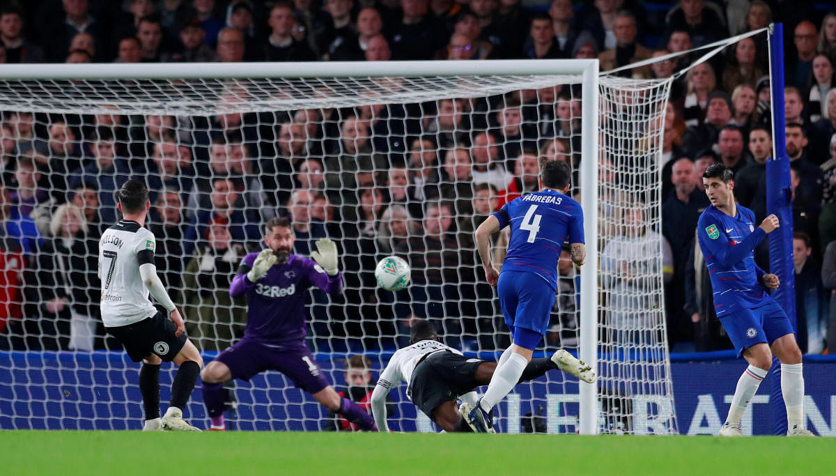 Chelsea's Cesc Fabregas (second from right) scores the winner during their League Cup clash against Derby County. Reuters