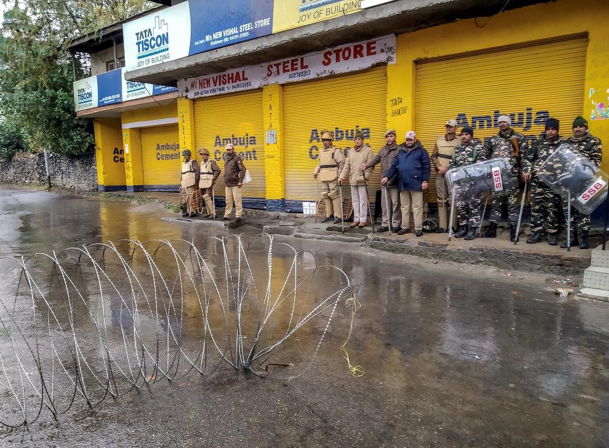Security personnel stand guard during curfew after a senior BJP leader Anil Parihar (52) and his brother Ajeet (55), were killed by suspected militants on Thursday night, in Kishtwar, Jammu, Friday, Nov 02, 2018. (PTI Photo)