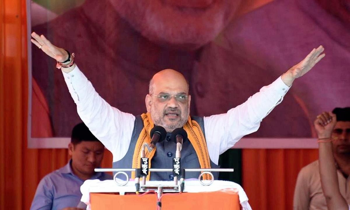 BJP president Amit Shah addresses an election rally in Ambagarh Chowki town under Khujji Assembly constituency of Rajnandgaon district of Chhattisgarh on Sunday. PTI