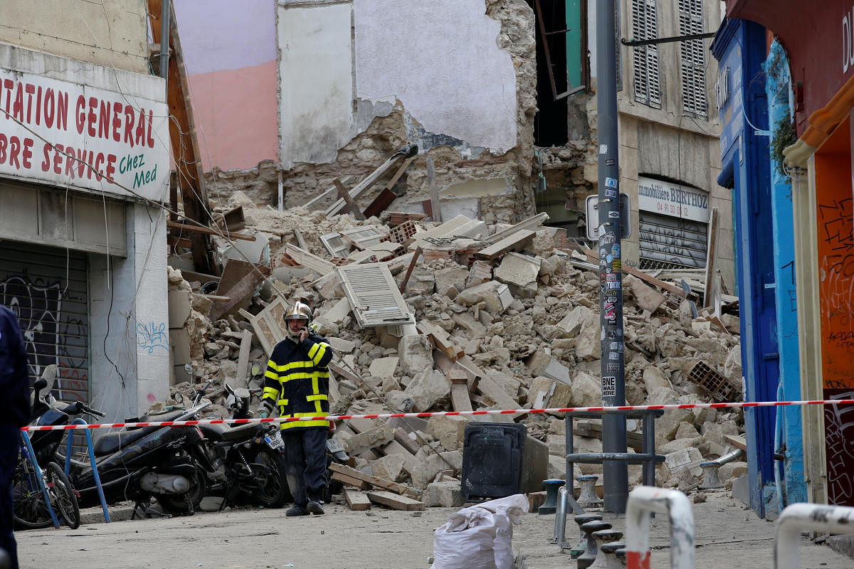 French rescue workers are seen near rubble after buildings collapsed in central Marseille. Reuters photo
