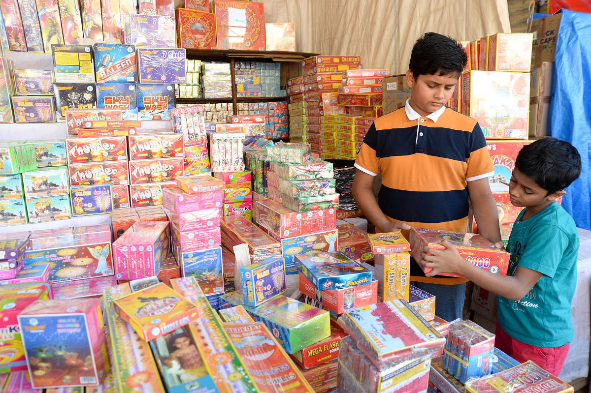 Boys shop for firecrackers in Malleswaram on Monday. DH PHOTO/SATISH BADIGER