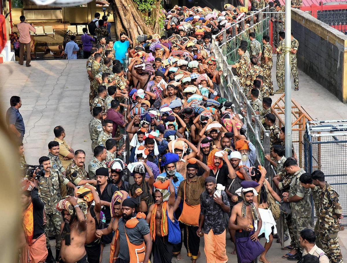 Devotees arrive at Sabarimala Temple, in Pathanamthitta District on Monday. This is the second time the hill temple will open for 'darshan' after the Supreme Court allowed entry of women of all age groups into it. PTI