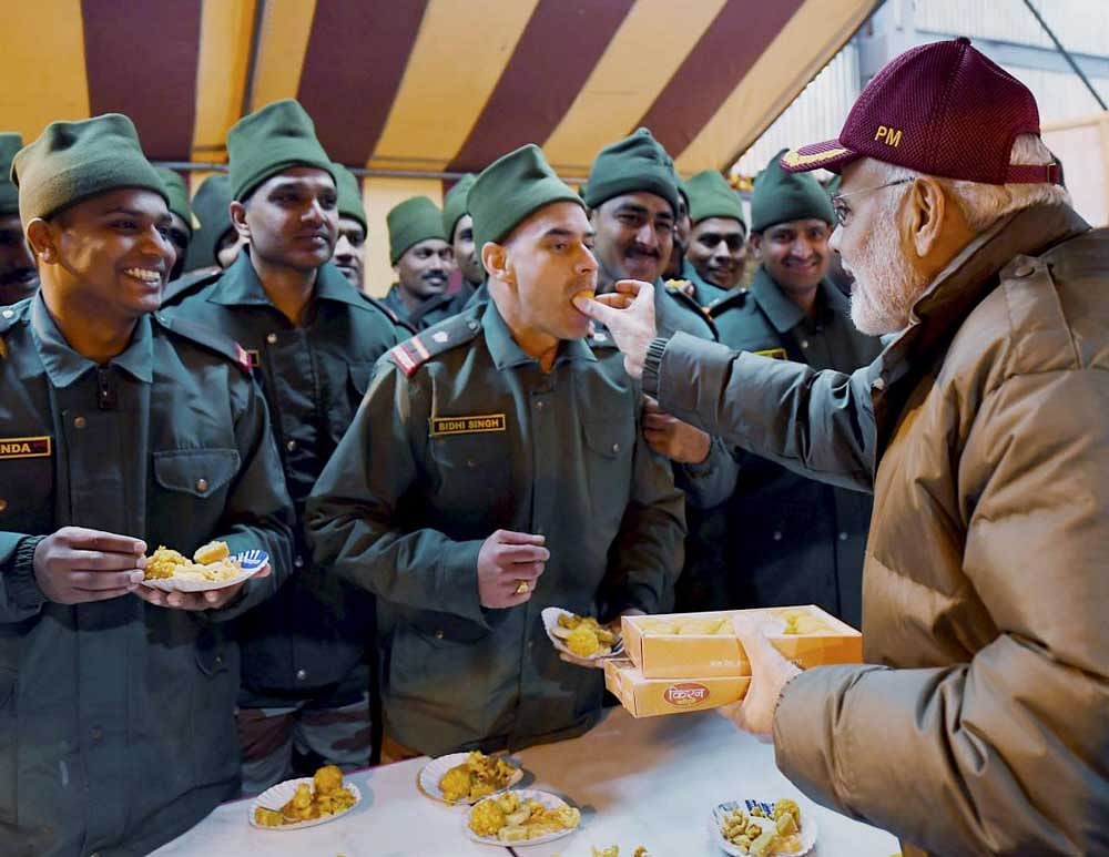 Prime Minister Narendra Modi celebrating Diwali with the jawans of the Indian Army and ITBP, at Harsil, in Uttarakhand on Wednesday. PTI Photo