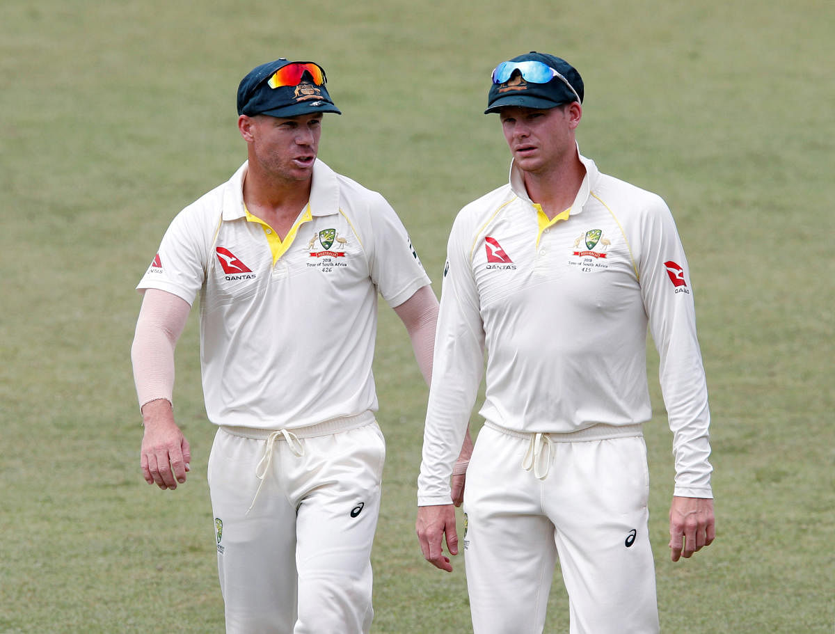 Cricket Australia is considering a demand by the players' union that ball-tampering bans on former captain Steve Smith (right) and David Warner be lifted immediately. REUTERS