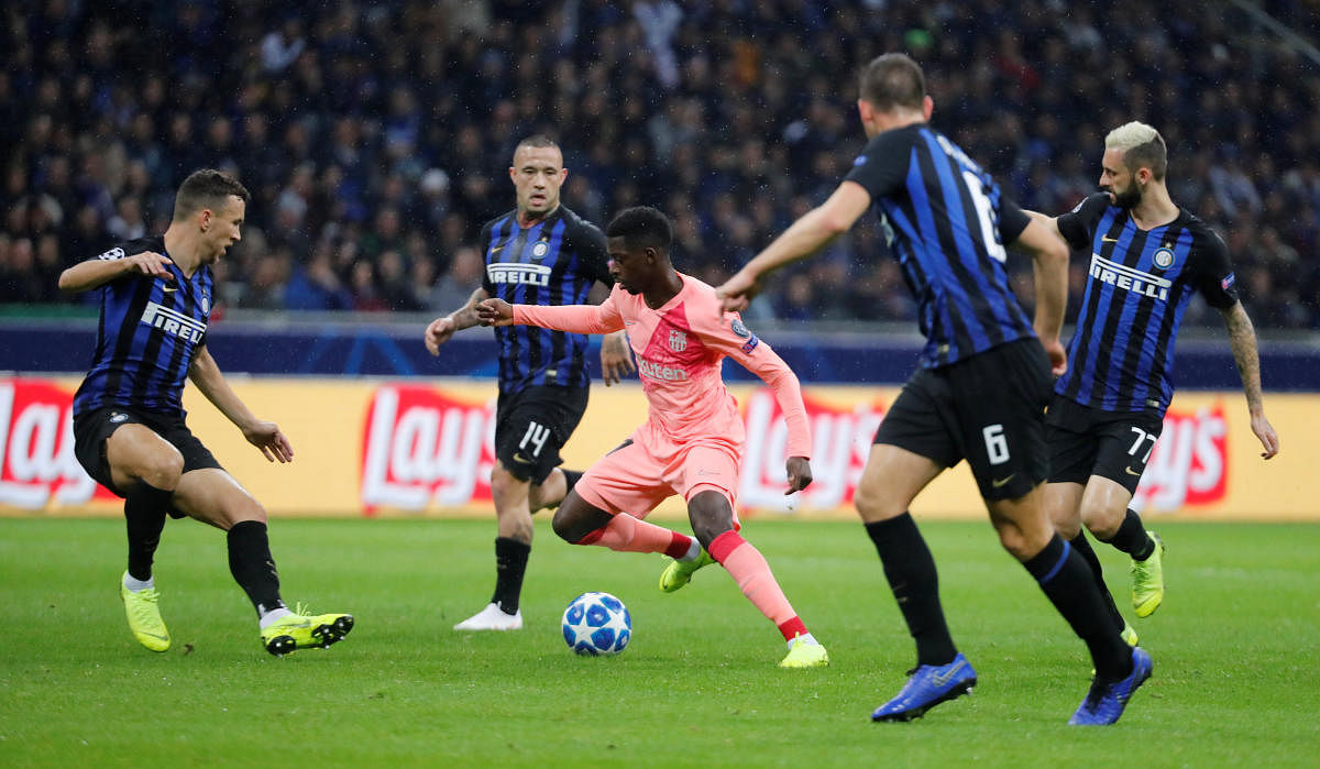Barcelona's Ousmane Dembele in action with Inter Milan's Ivan Perisic, Radja Nainggolan and Marcelo Brozovic during the UEFA Champions League group stage match at the San Siro. (REUTERS)
