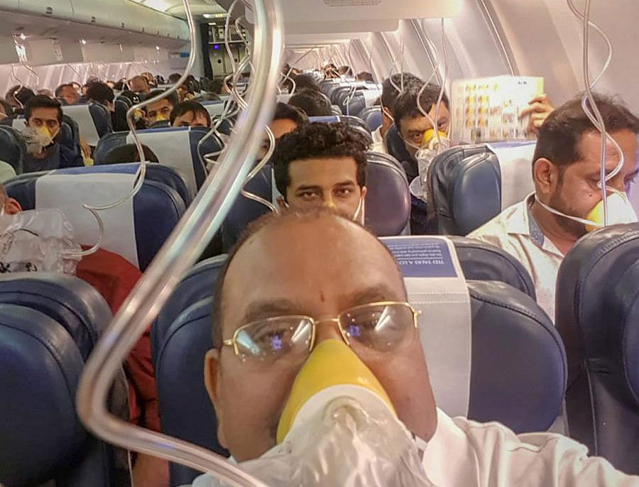 Passengers on board the Mumbai-Jaipur Jet Airways flight wear oxygen masks during an emergency after cabin pressure drop, in Mumbai, Thursday. PTI file photo