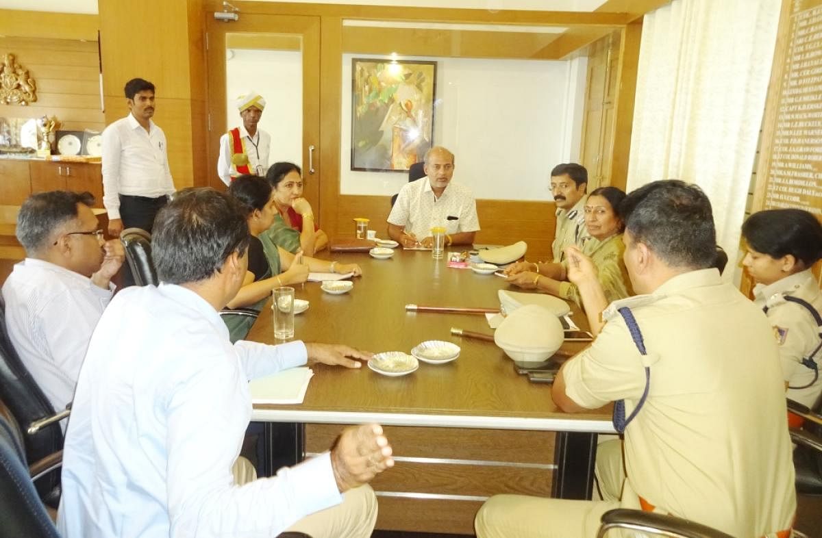 District In-charge Minister Sa Ra Mahesh chairs a meeting in Madikeri on Wednesday.