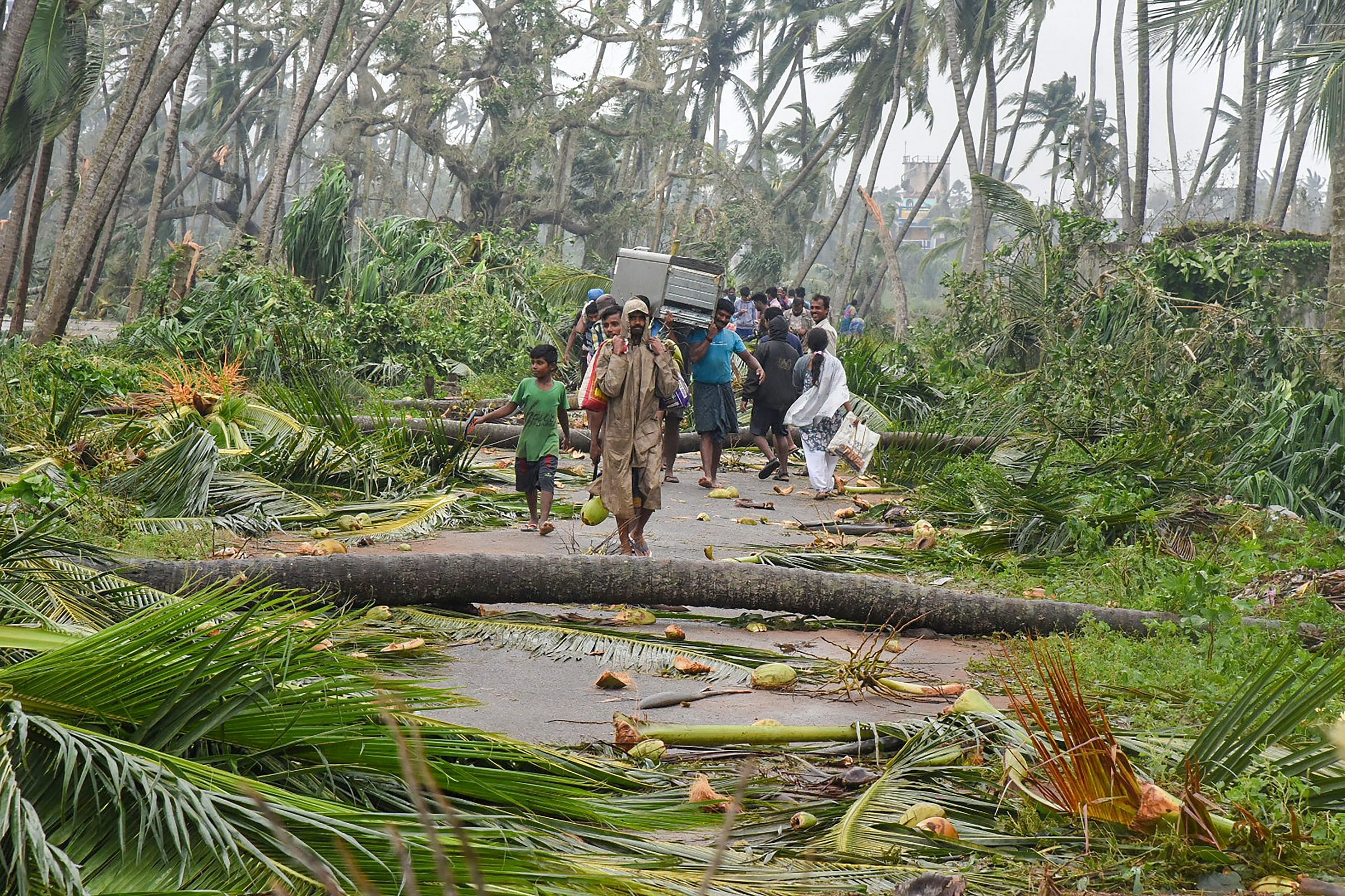 A group of people relocate to safer places as Cyclone Titli hits Barua village, in Srikakulam, on October 11, 2018. PTI file photo