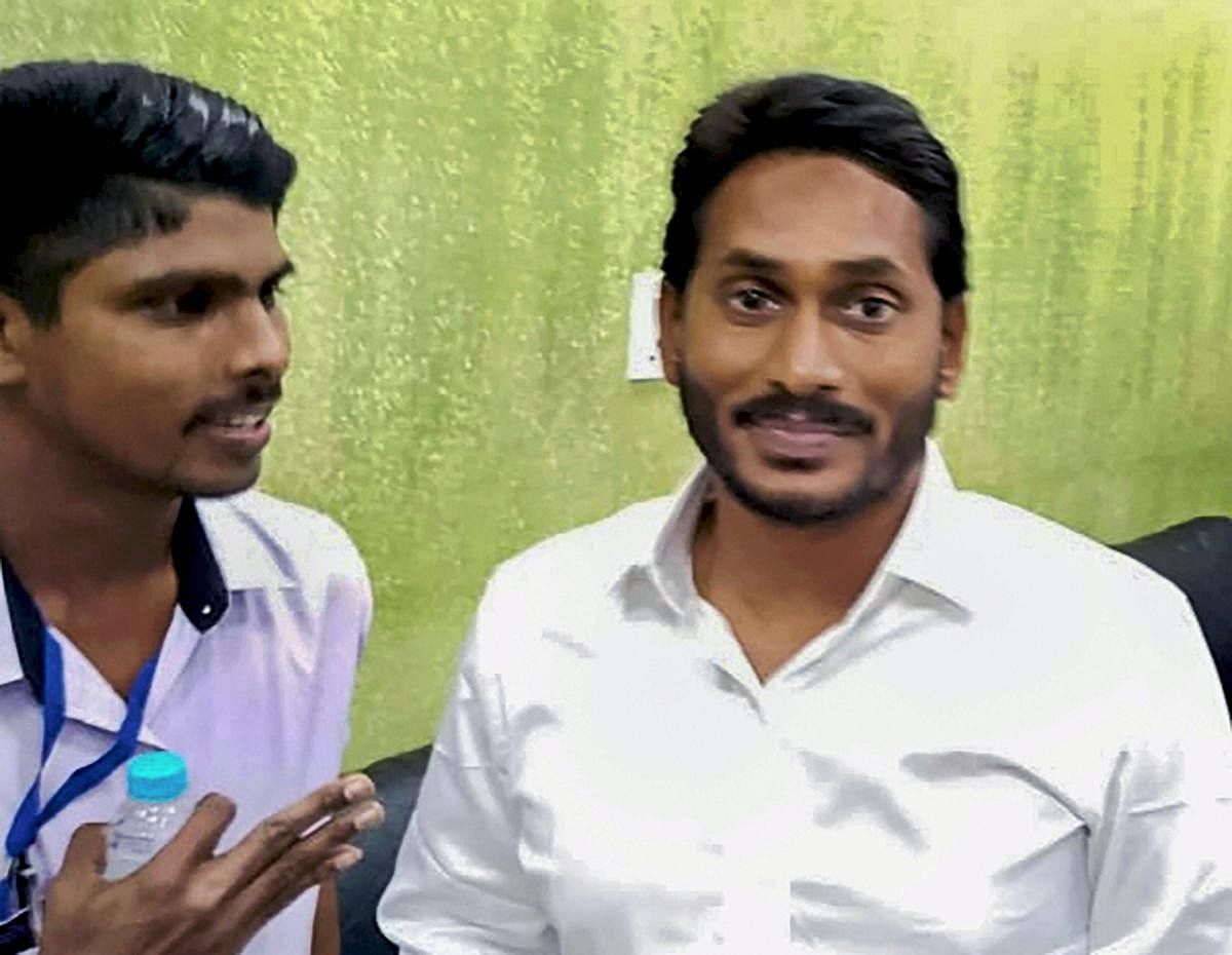 YSR Congress Party Chief Jagan Mohan Reddy before he was stabbed on his arm by J Srinivasa Rao (L), at Visakhapatnam Airport