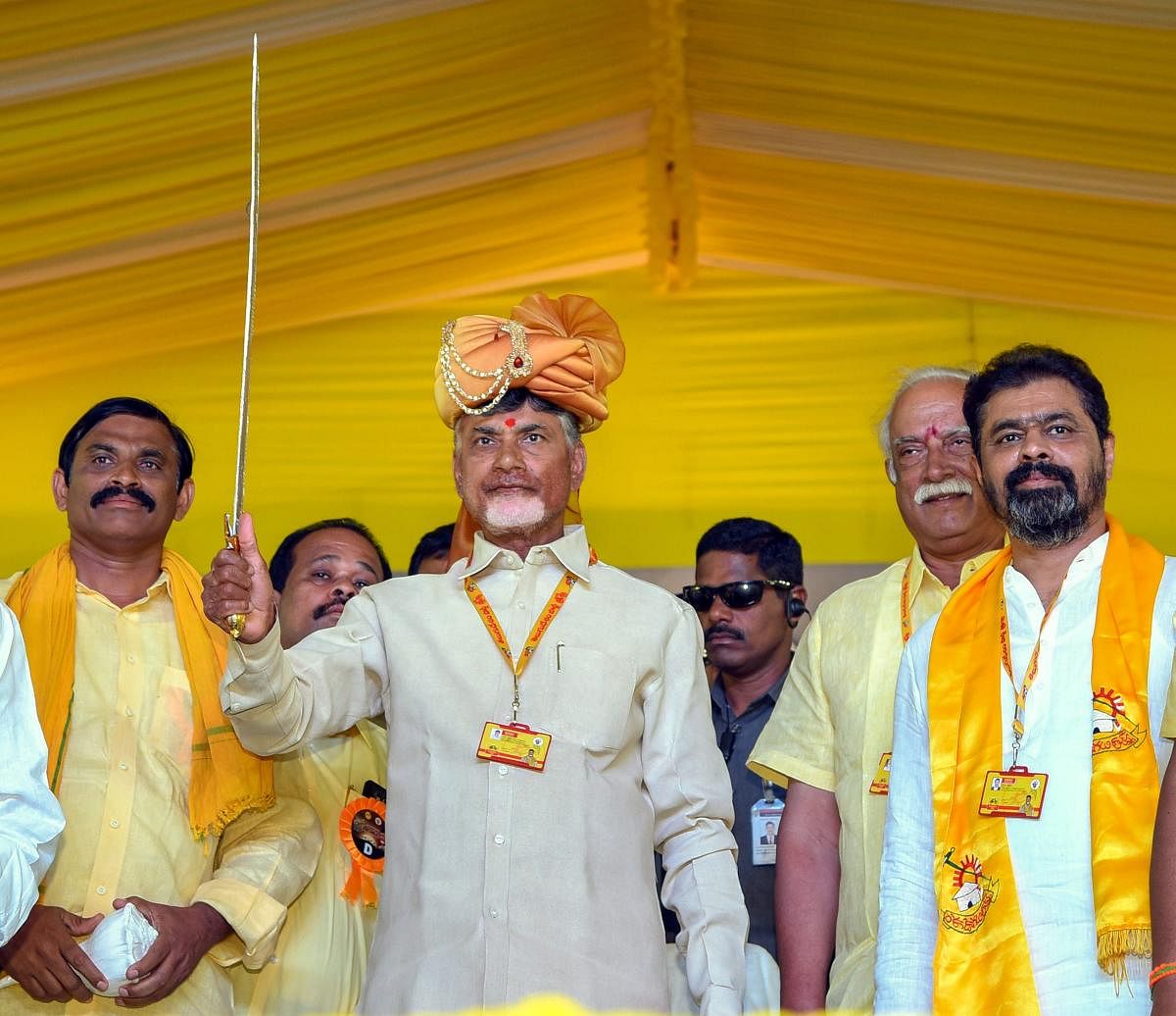 Andhra Pradesh Chief Minister Chandrababu Naidu holds a sword during 'Dharma Porata Deeksha' being held at Produturu, in Kadapa, on Tuesday. PTI